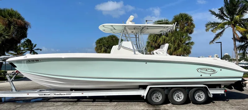 Slide: The Image of 2009 Spectre Sportfish boat on a trailer, parked outdoors. - 9