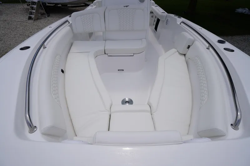 Slide: The Image of 2026 Tidewater 232 SS boat interior with white cushioned seating and stainless steel railings. - 10