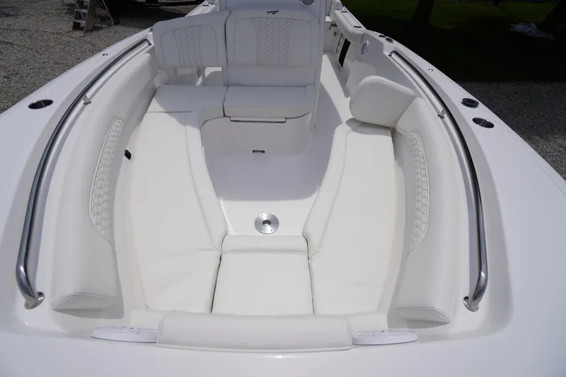 Slide: The Image of 2026 Tidewater 232 SS boat interior with white cushioned seating and stainless steel railings. - 13