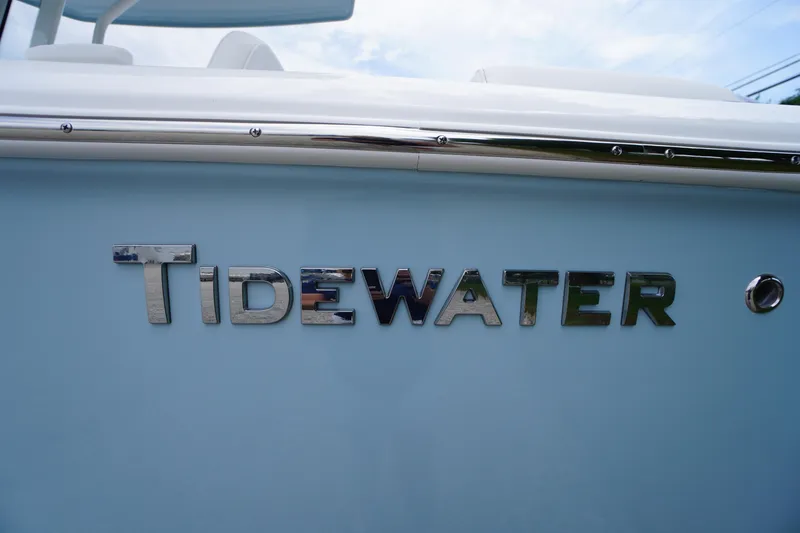 Slide: The Image of 2026 Tidewater 232 SS boat with chrome logo on light blue hull. - 3