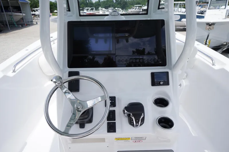 Slide: The Image of 2026 Tidewater 232 SS boat dashboard with steering wheel and electronic controls. - 34