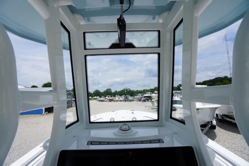 Slide: The Image of Interior view of 2026 Tidewater 232 SS boat, showcasing helm and windshield design. - 36