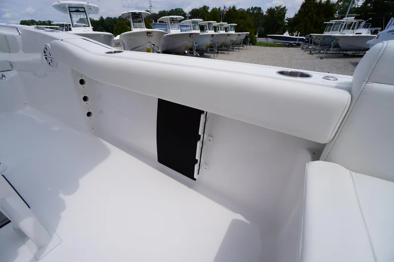 Slide: The Image of 2026 Tidewater 232 SS boat interior with white seating and cup holders. - 46