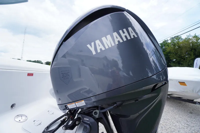 Slide: The Image of Yamaha outboard motor on 2026 Tidewater 232 SS boat, parked outdoors. - 78