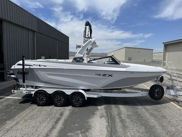 The Image of 2021 Tigé 25ZX boat on trailer in front of storage buildings. - 1