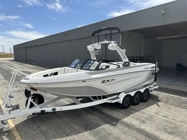 Slide: The Image of 2021 Tigé 25ZX boat on trailer outside warehouse. - 3