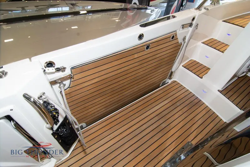 Slide: The Image of 2022 Jeanneau Leader 10.5 boat interior with teak flooring and steps. - 32