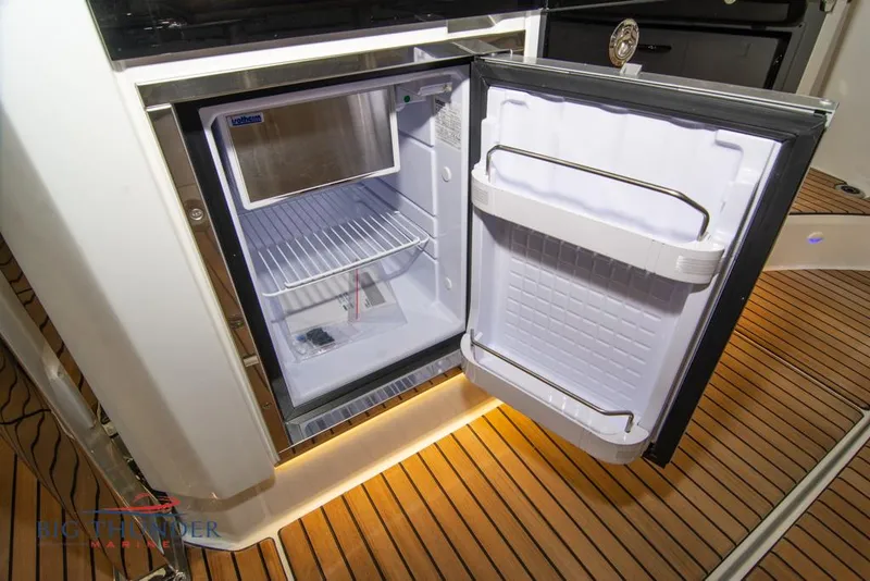 Slide: The Image of Open refrigerator on Jeanneau Leader 10.5 boat, showcasing interior storage space, 2022 model. - 36