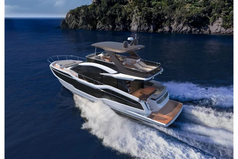 Slide: The Image of 2023 Galeon 560 Fly luxury yacht cruising near rocky coastline. - 5