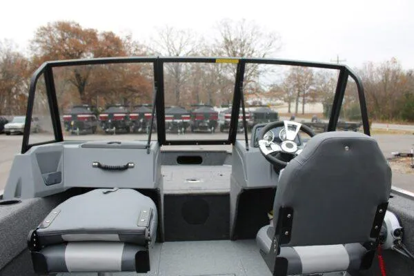 Slide: The Image of 2023 Lowe Fishing Machine 162 boat interior with steering console and seating. - 10