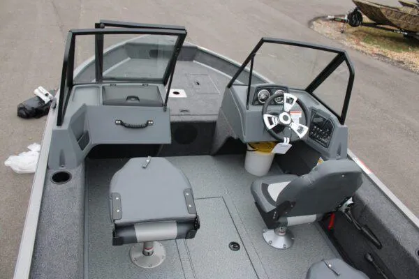 Slide: The Image of 2023 Lowe FISHING MACHINE 162 interior, featuring dual seats, steering console, and spacious deck. - 11