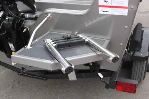 Slide: The Image of 2023 Lowe FISHING MACHINE 162 boat rear view with ladder and safety instructions. - 4