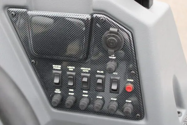 Slide: The Image of Control panel of 2023 Lowe FISHING MACHINE 162 boat with switches and 12V outlet. - 7
