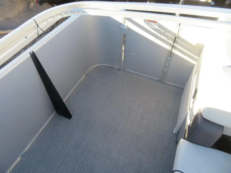 Slide: The Image of 2023 Starcraft EX 22 C boat interior, showing clean, spacious deck area. - 13