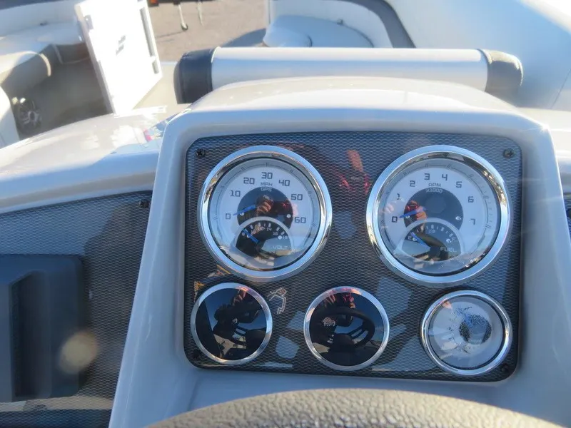 Slide: The Image of 2023 Starcraft EX 22 C boat dashboard with gauges and controls. - 14