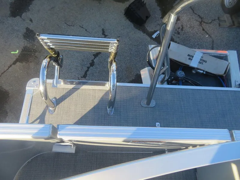 Slide: The Image of 2023 Starcraft EX 22 C boat with a foldable ladder on the deck. - 18