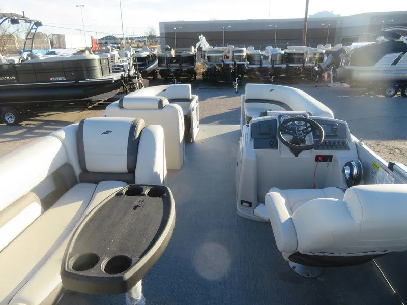 Slide: The Image of 2023 Starcraft EX 22 C pontoon boat interior with seating and control console. - 19