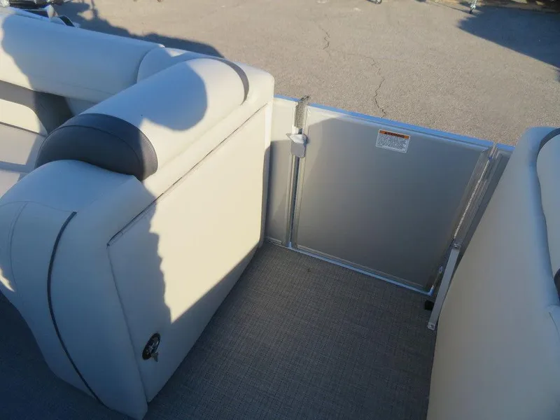 Slide: The Image of 2023 Starcraft EX 22 C boat interior with beige seating and gate. - 8