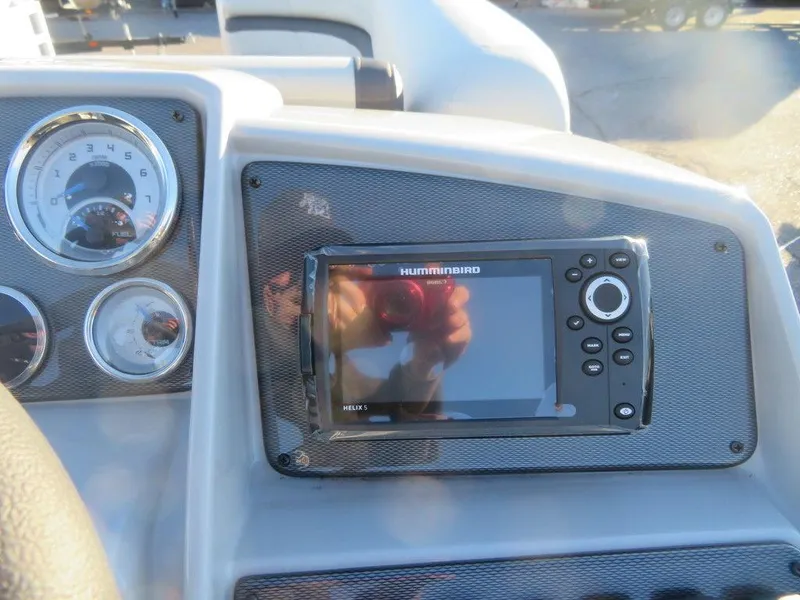 Slide: The Image of 2023 Starcraft EX 22 C dashboard with Humminbird fish finder and gauges. - 9