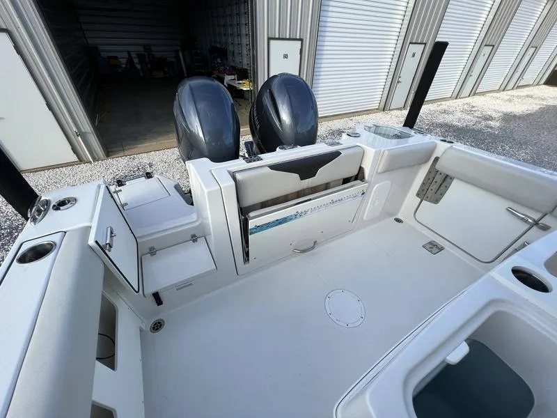 Slide: The Image of 2022 Sailfish 272 CC boat with dual outboard motors in storage facility. - 10