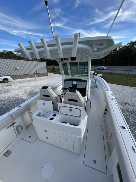 Slide: The Image of 2022 Sailfish 272 CC center console boat with dual captain's chairs and rod holders. - 12