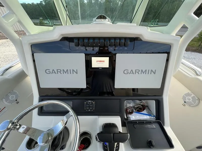 Slide: The Image of 2022 Sailfish 272 CC boat dashboard with Garmin navigation systems. - 15