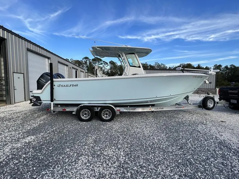 Slide: The Image of 2022 Sailfish 272 CC boat on a trailer, parked outdoors near a building. - 7