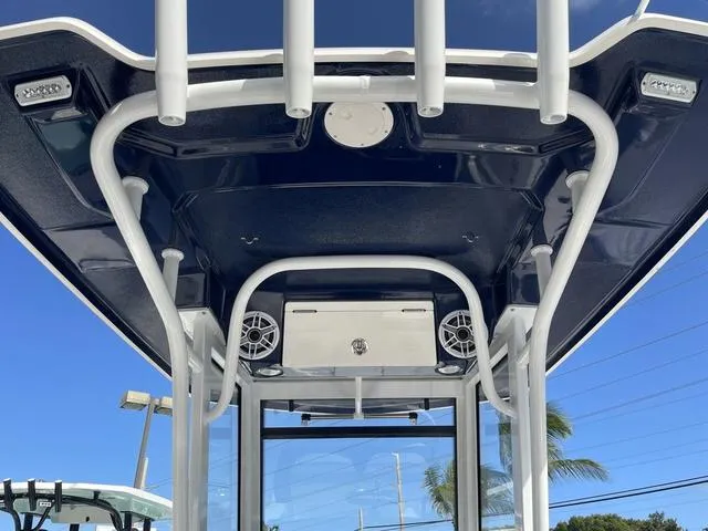 Slide: The Image of 2023 Robalo 266 Cayman boat T-top with speakers and rod holders. - 14