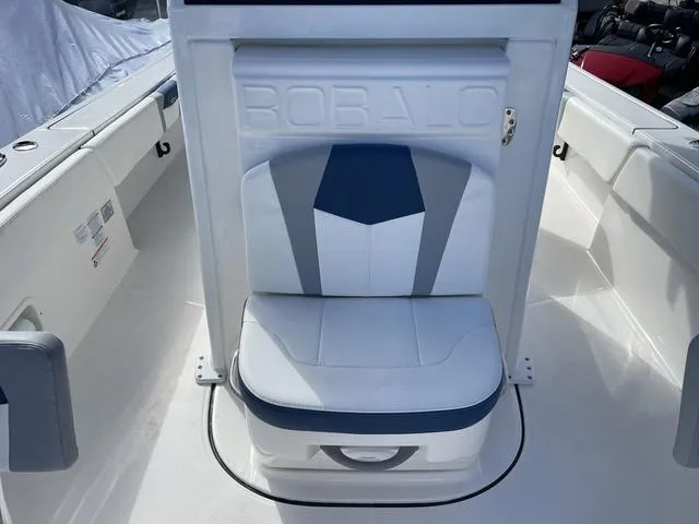 Slide: The Image of 2023 Robalo 266 Cayman boat seat with white and blue upholstery. - 20