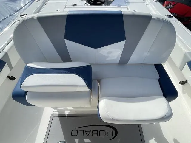 Slide: The Image of 2023 Robalo 266 Cayman boat seating with blue and white upholstery. - 21