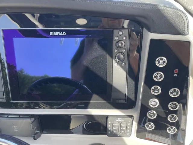 Slide: The Image of 2023 Robalo 266 Cayman dashboard with Simrad display and control buttons. - 6