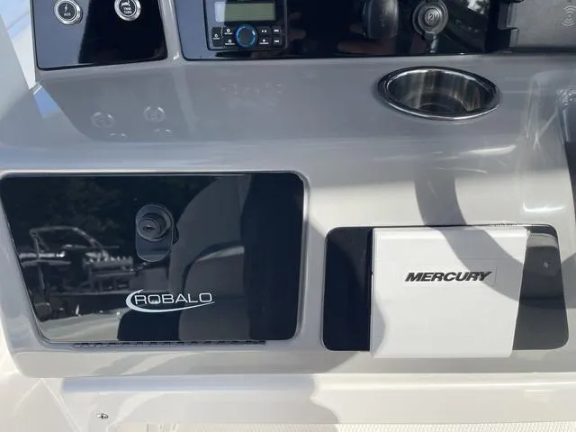 Slide: The Image of 2023 Robalo 266 Cayman boat dashboard with Mercury controls. - 8