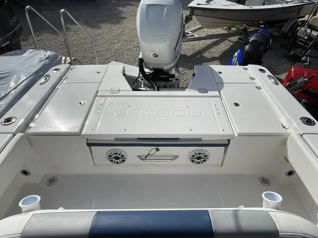 Slide: The Image of 2023 Robalo 266 Cayman boat stern with outboard motor and storage compartments. - 9
