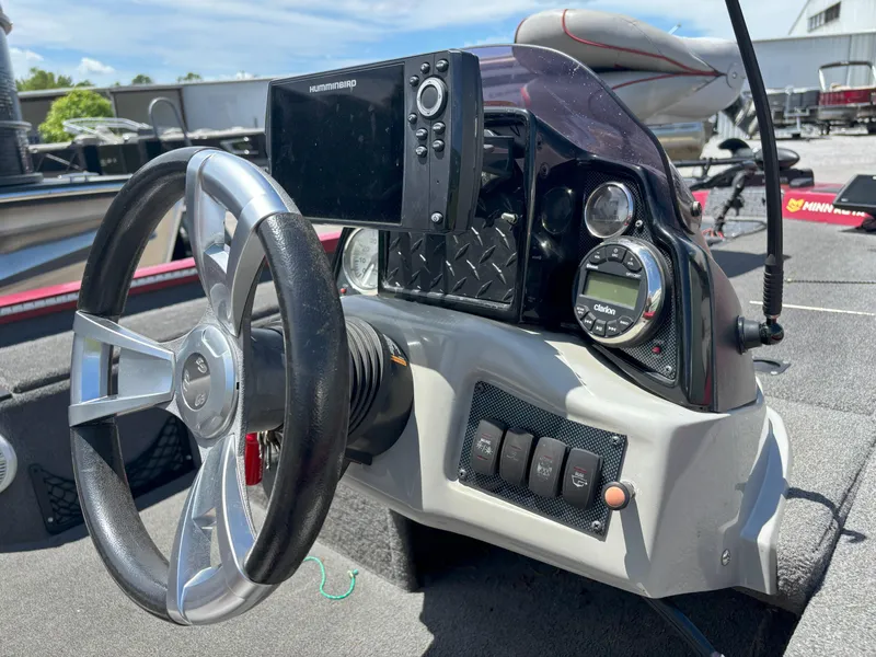 Slide: The Image of 2018 G3 Sportsman 1710 boat dashboard with steering wheel and electronic controls. - 15