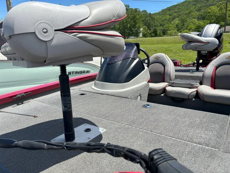 Slide: The Image of 2018 G3 Sportsman 1710 boat interior with seating and console, outdoors on a sunny day. - 3