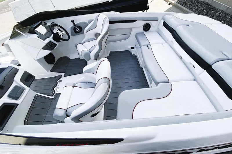 Slide: The Image of 2023 Tahoe 210 Si Limited boat interior with sleek white seating and modern dashboard design. - 10