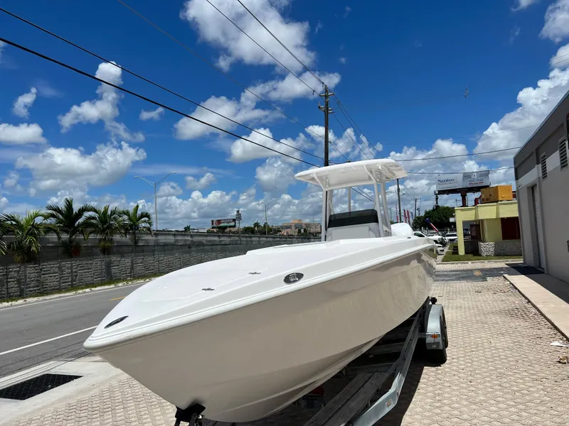 Slide: The Image of 1979 Wellcraft Scarab Sport 302 boat on a trailer under a clear blue sky. - 10