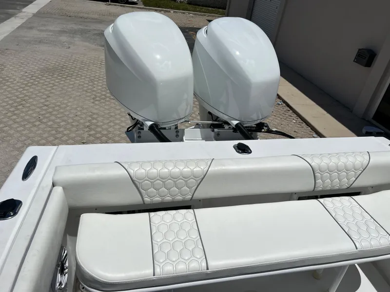 Slide: The Image of 1979 Wellcraft Scarab Sport 302 with twin outboard engines and white cushioned seating. - 11