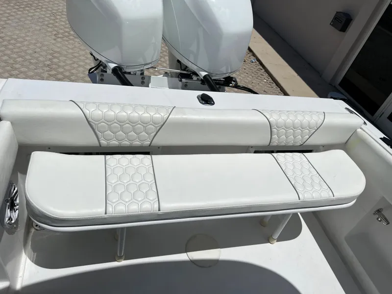 Slide: The Image of 1979 Wellcraft Scarab Sport 302 boat with white cushioned seating and twin outboard motors. - 12