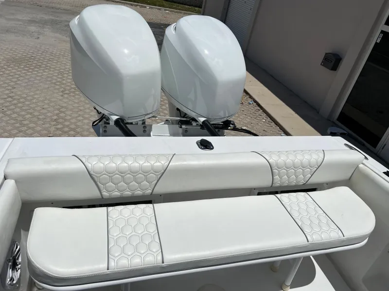 Slide: The Image of 1979 Wellcraft Scarab Sport 302 boat with twin outboard engines and white cushioned seating. - 13