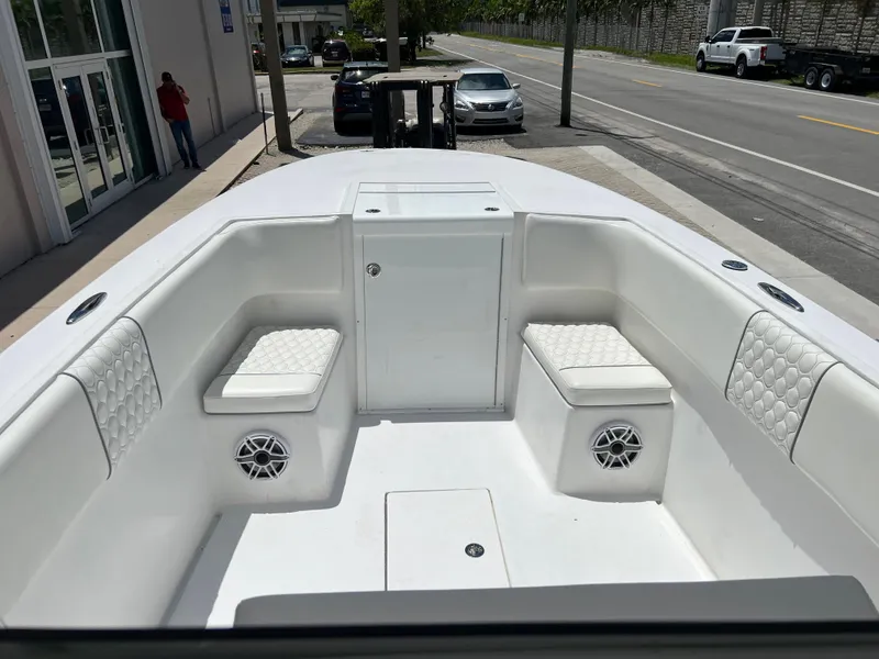 Slide: The Image of 1979 Wellcraft Scarab Sport 302 boat interior with white seating and speakers. - 21