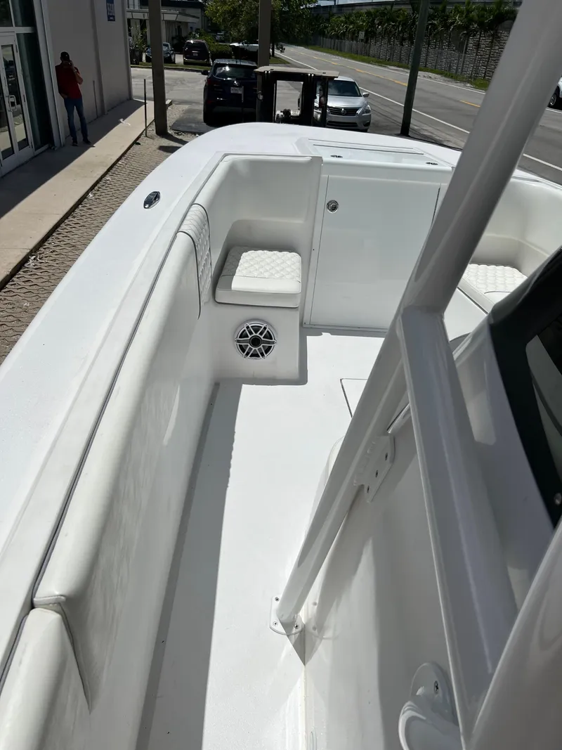 Slide: The Image of 1979 Wellcraft Scarab Sport 302 boat interior with white seating and speaker. - 22