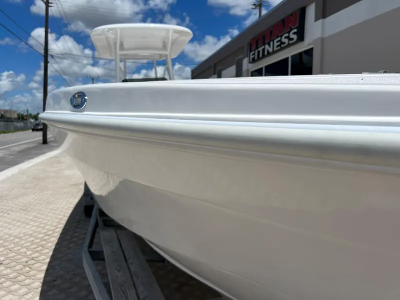 Slide: The Image of 1979 Wellcraft Scarab Sport 302 boat side view, white hull, parked near Titan Fitness. - 27