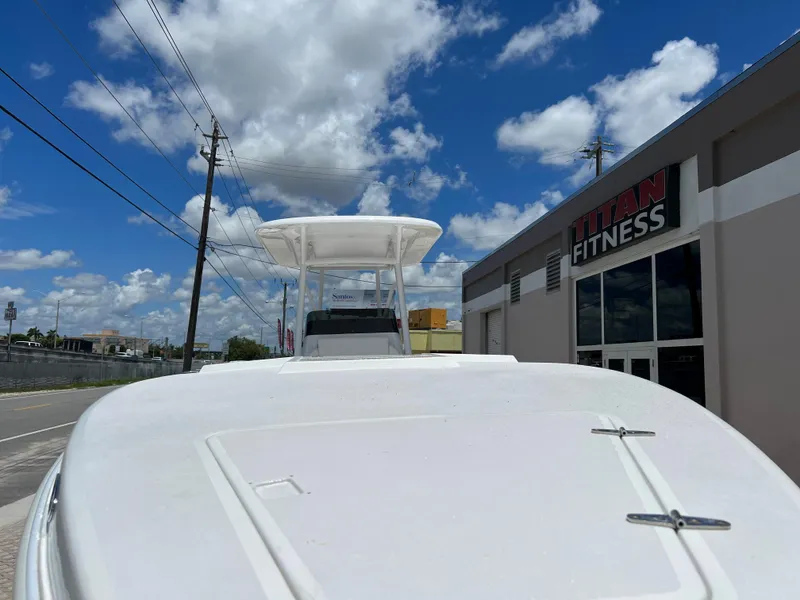 Slide: The Image of 1979 Wellcraft Scarab Sport 302 boat near Titan Fitness under a blue sky. - 29