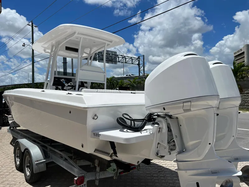 Slide: The Image of 1979 Wellcraft Scarab Sport 302 boat with twin outboard engines on a trailer. - 3