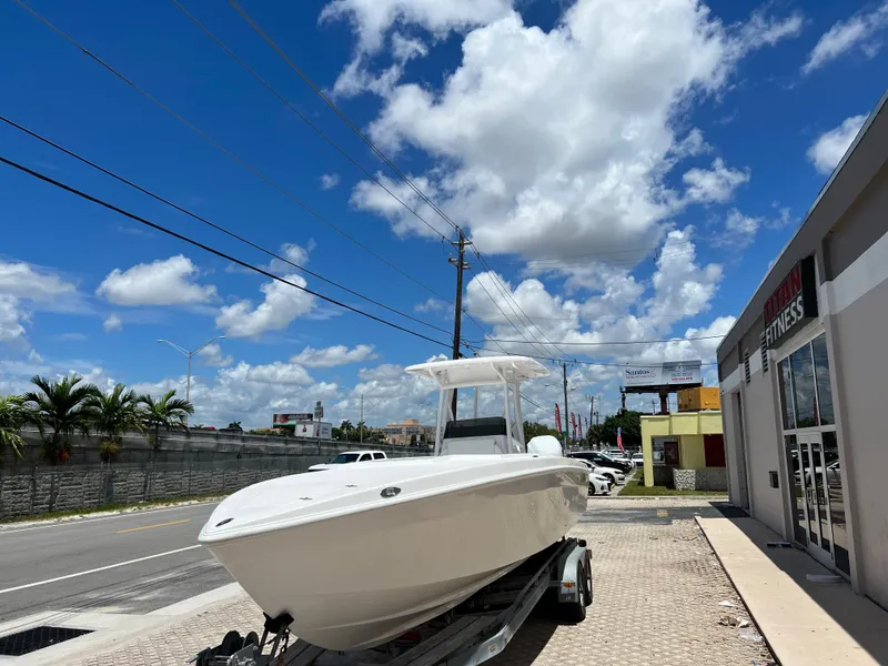 Slide: The Image of 1979 Wellcraft Scarab Sport 302 boat on trailer under a bright blue sky. - 30