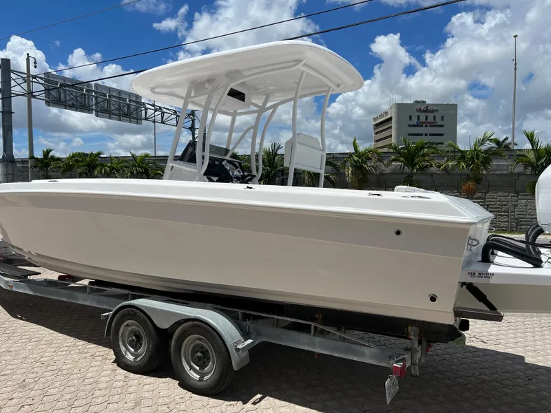 Slide: The Image of 1979 Wellcraft Scarab Sport 302 boat on a trailer under a blue sky. - 4