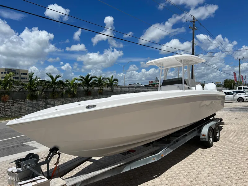 Slide: The Image of 1979 Wellcraft Scarab Sport 302 boat on a trailer under a clear blue sky. - 5