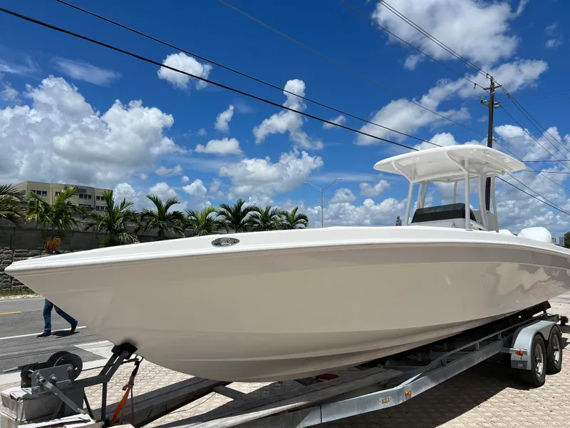 Slide: The Image of 1979 Wellcraft Scarab Sport 302 boat on a trailer under a clear blue sky. - 7