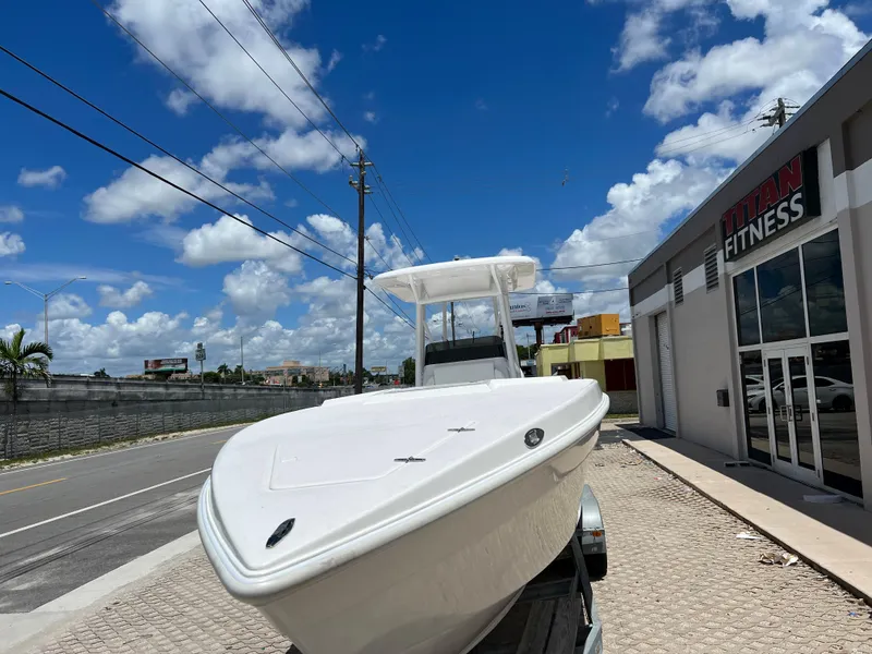 Slide: The Image of 1979 Wellcraft Scarab Sport 302 boat on a trailer under a clear blue sky. - 8